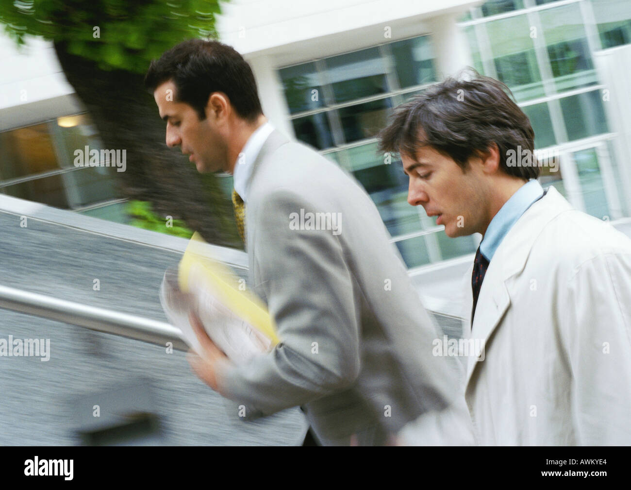 Two businessmen walking up stairs, upper section,  blurred Stock Photo