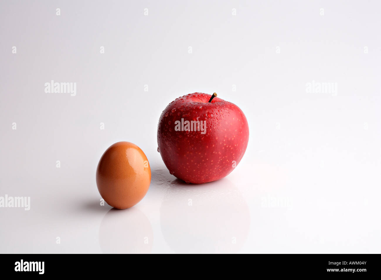 Boskoop apple beside a brown egg Stock Photo