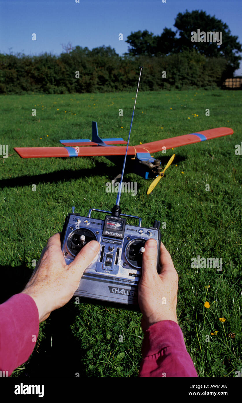 man using radio remote control to operate model aircraft uk Stock Photo