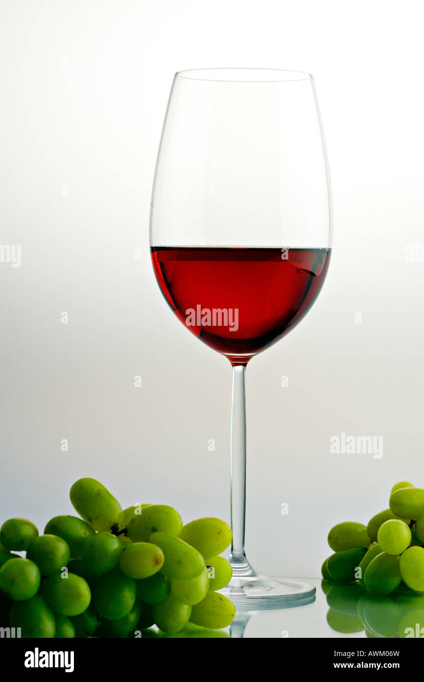 Greed grapes beside a glass of red wine Stock Photo