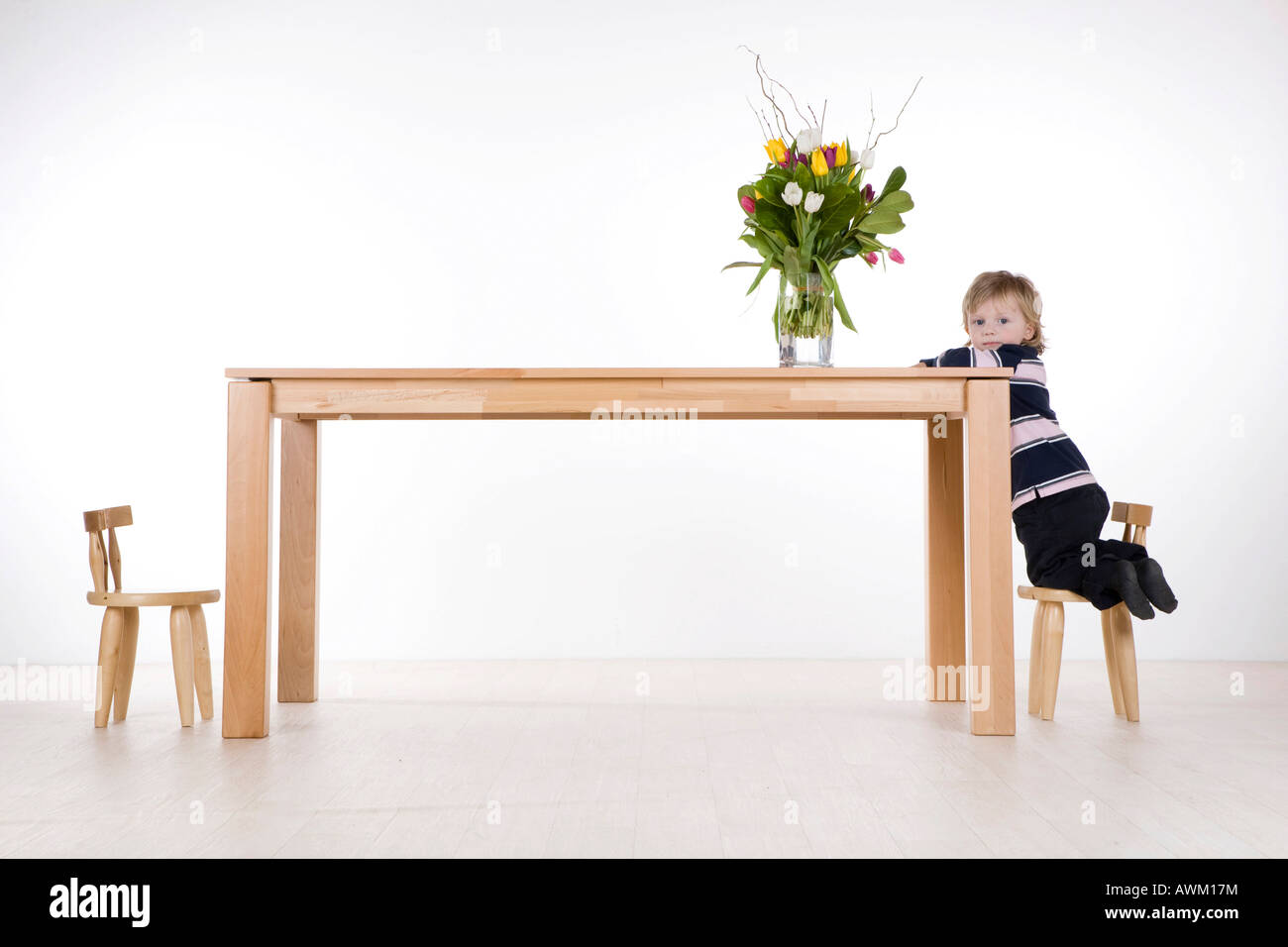 Boy, climbing on a table Stock Photo