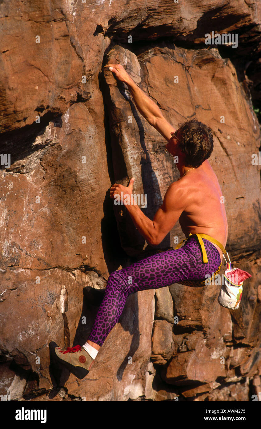 Side profile of man rock climbing Stock Photo