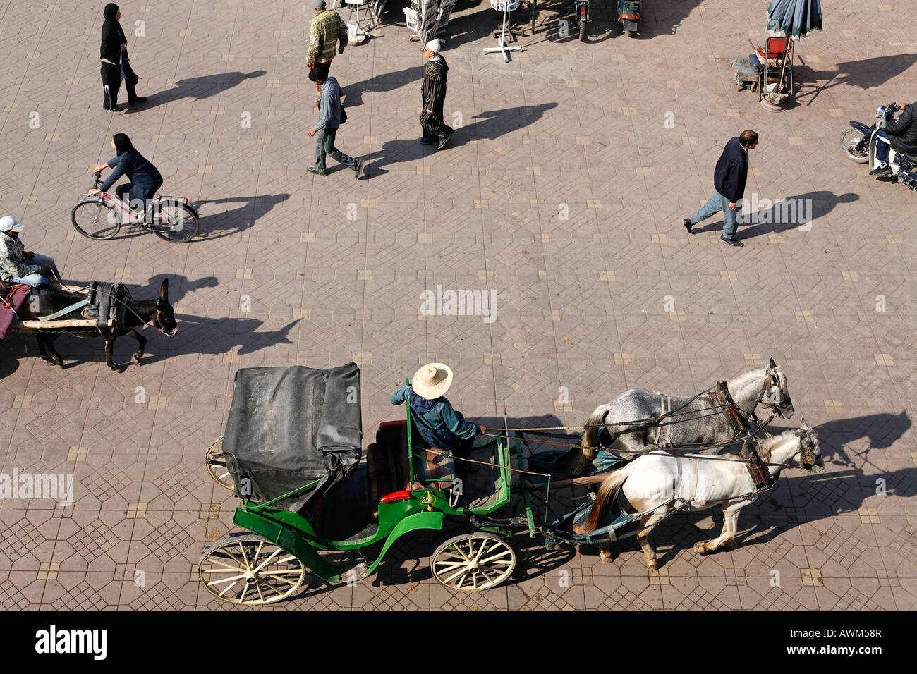 Horse-drawn carriage and pedestrians at Djemaa el-Fna, Marrakech, Morocco, Africa Stock Photo