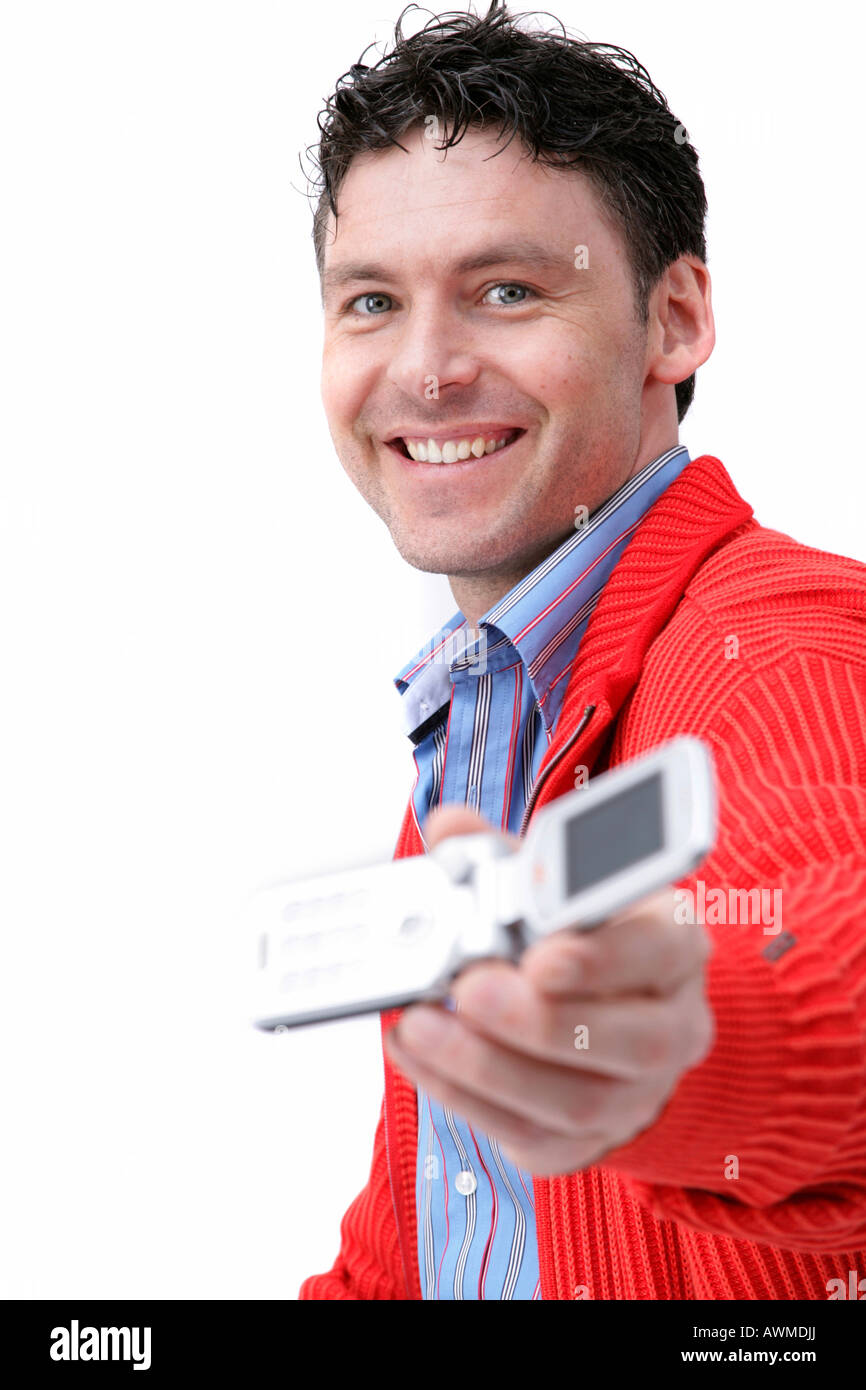 Man holding mobile phone, laughing Stock Photo