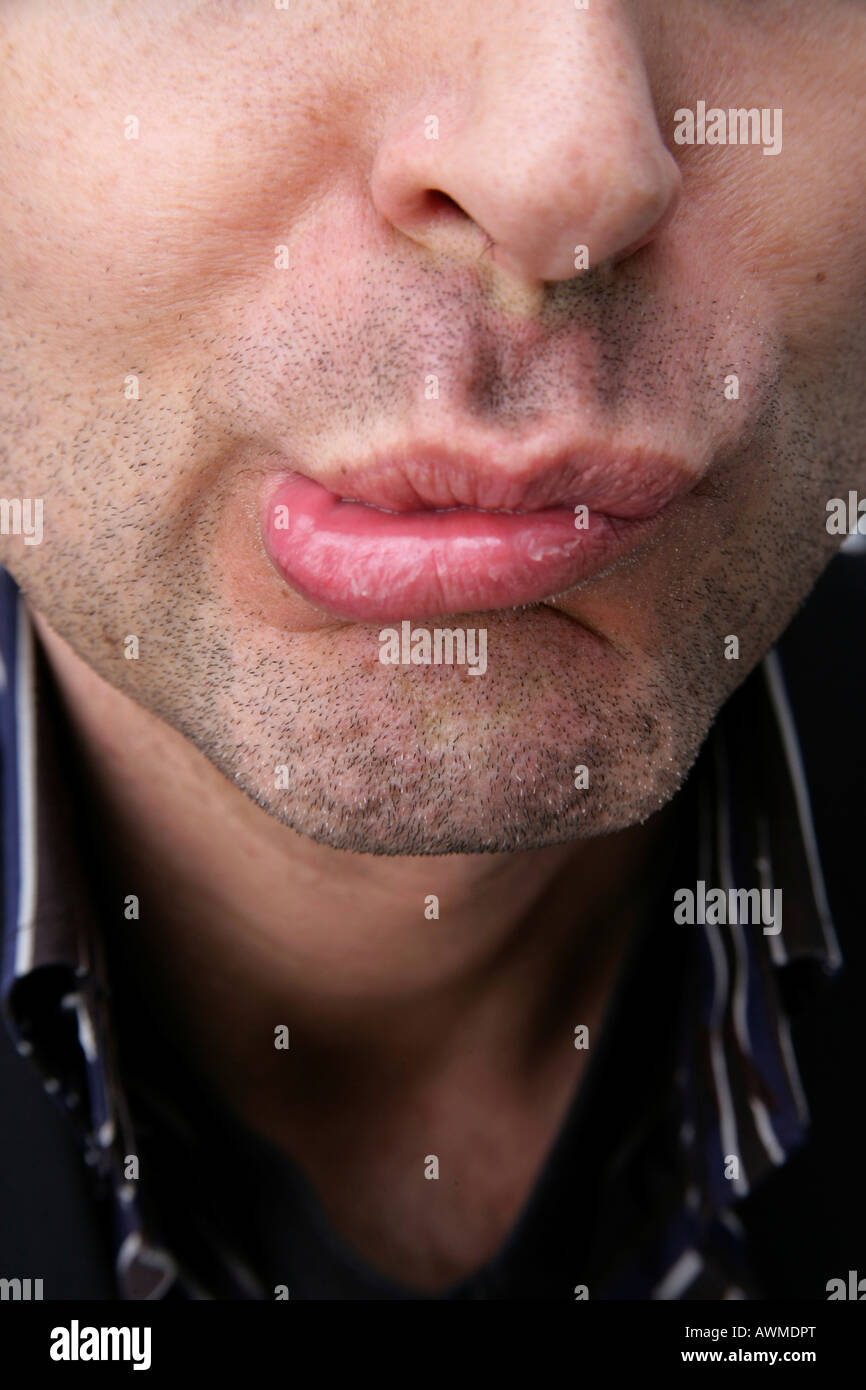 Man grimacing, close-up of his mouth Stock Photo