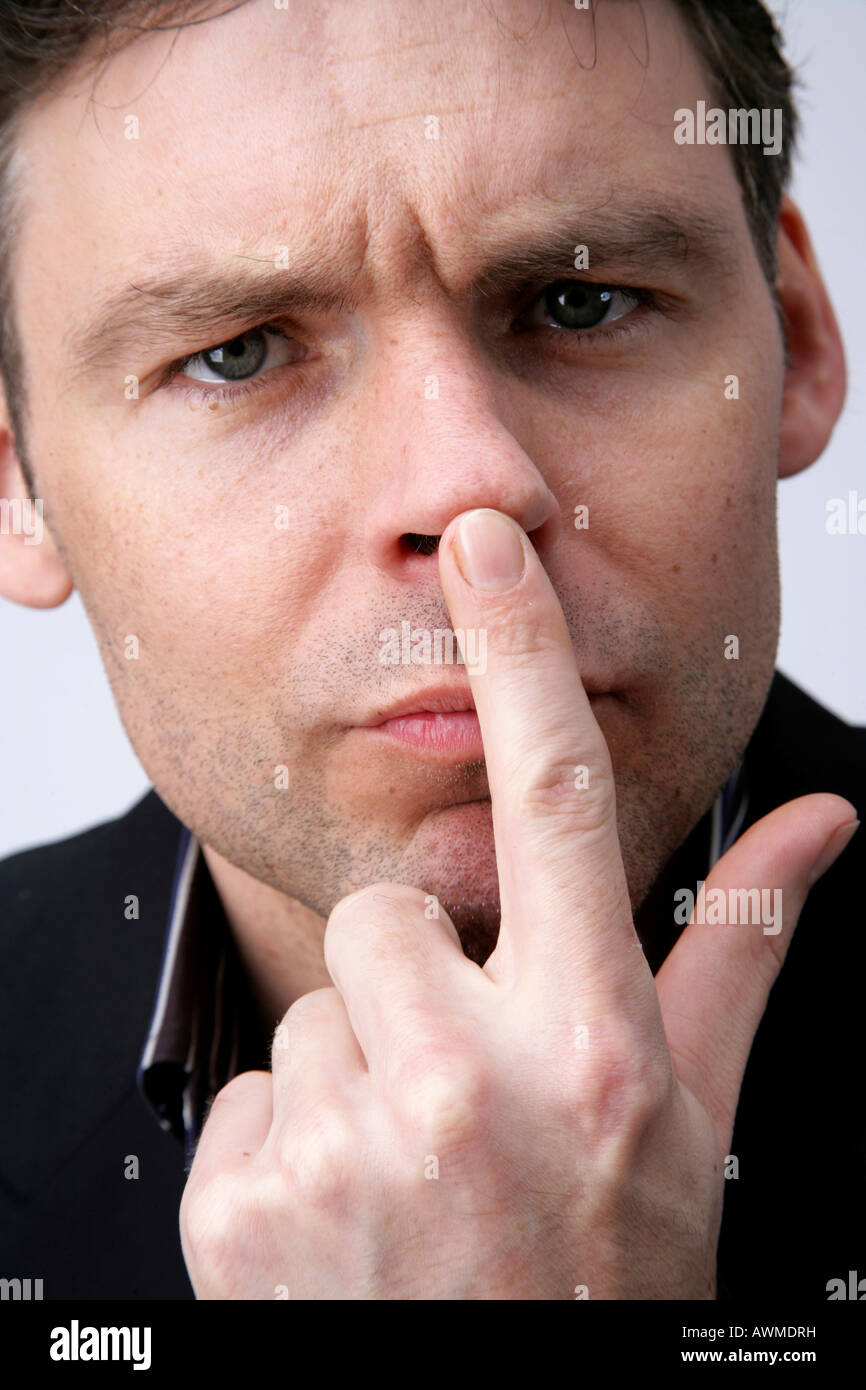 Man pointing to his nose Stock Photo