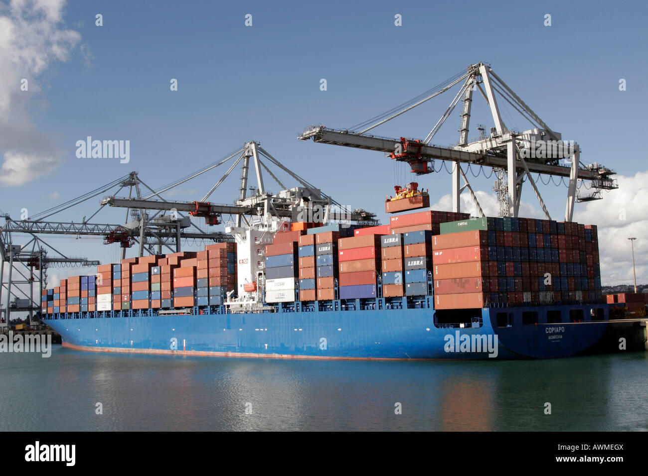 Crane lifting containers onto the Copiapo container ship the Port of Le
