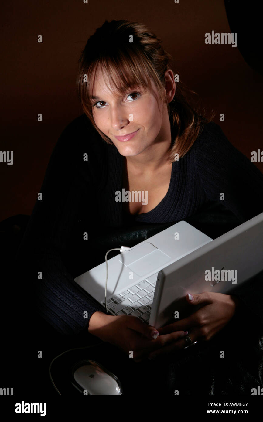 Young woman holding laptop in her arm Stock Photo - Alamy
