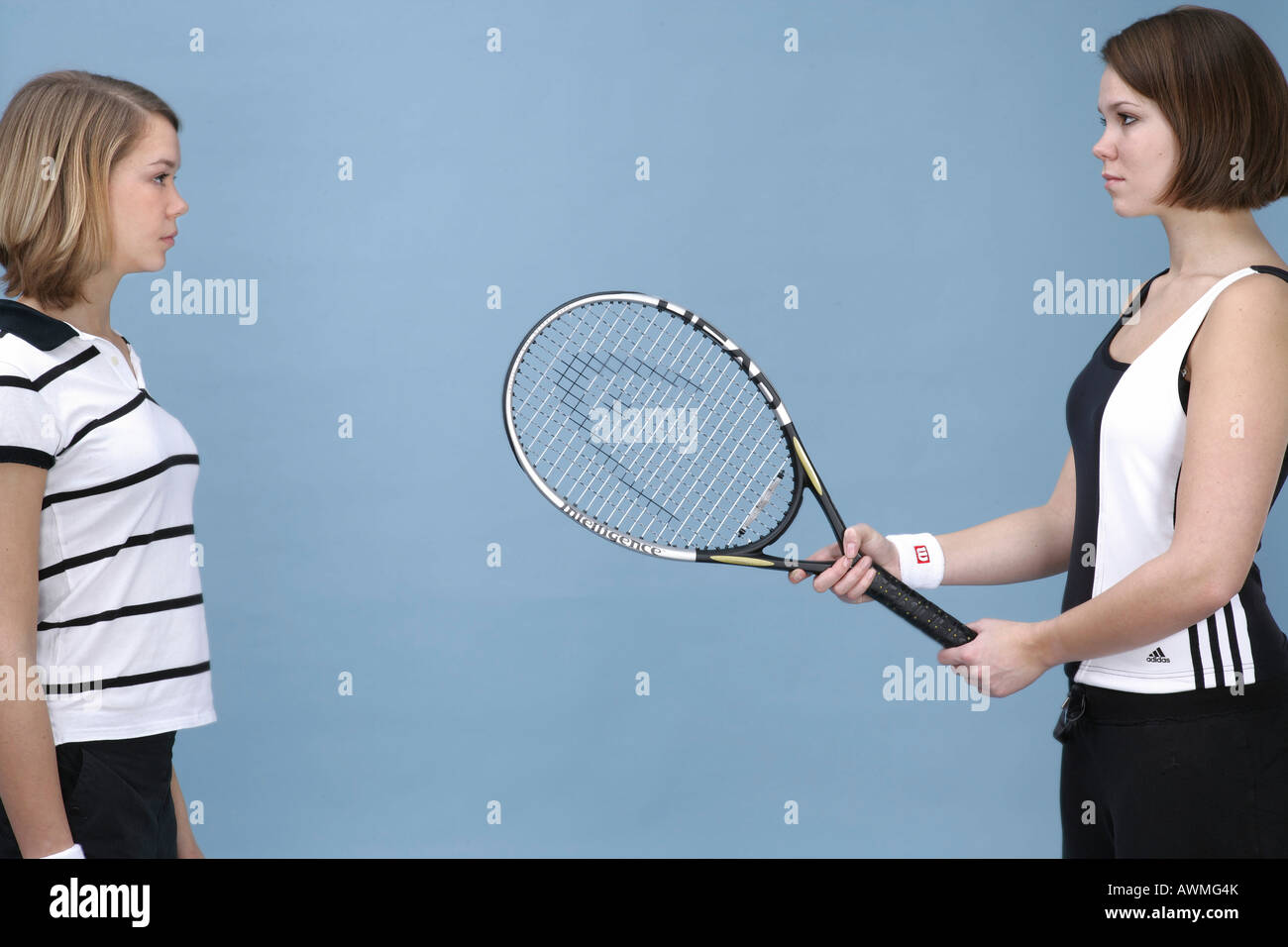 Two girls dressed in sportswear with a tennis racket Stock Photo