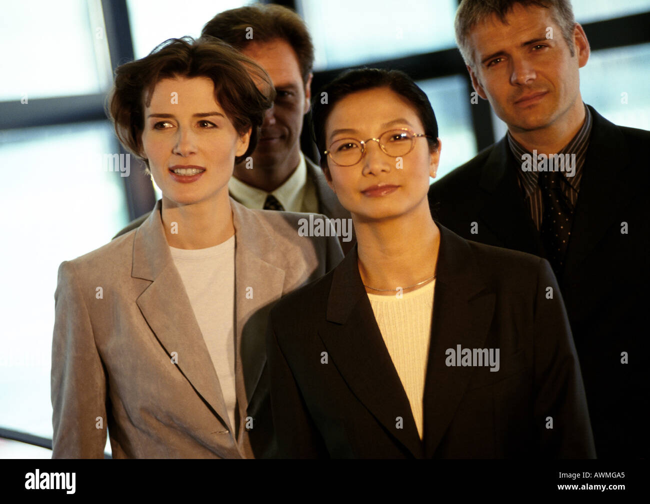 Four business people grouped together Stock Photo
