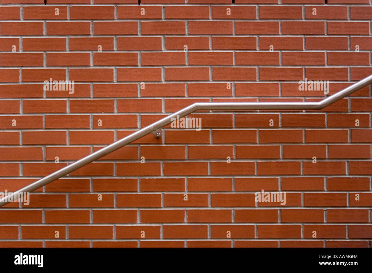 Ascending handrail along a red brick wall Stock Photo Alamy
