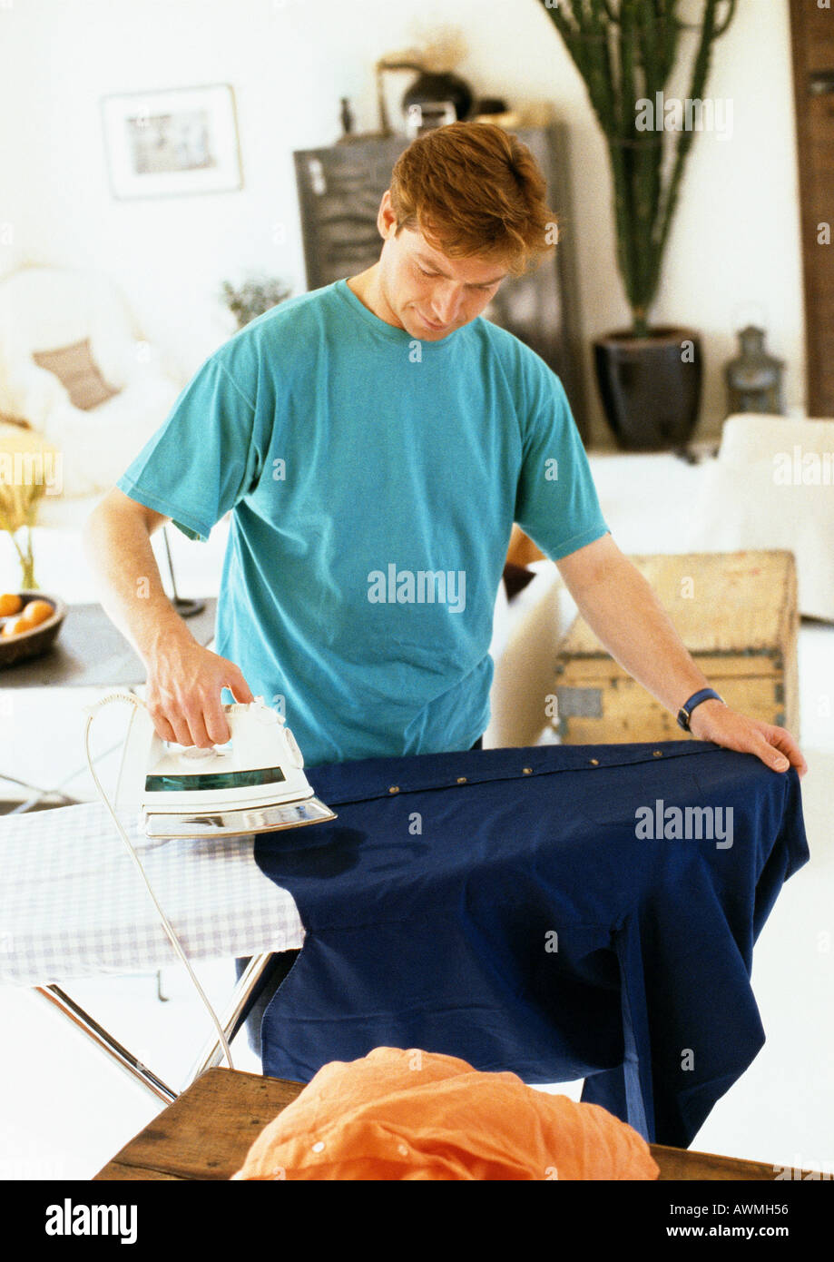 Man ironing clothes Stock Photo