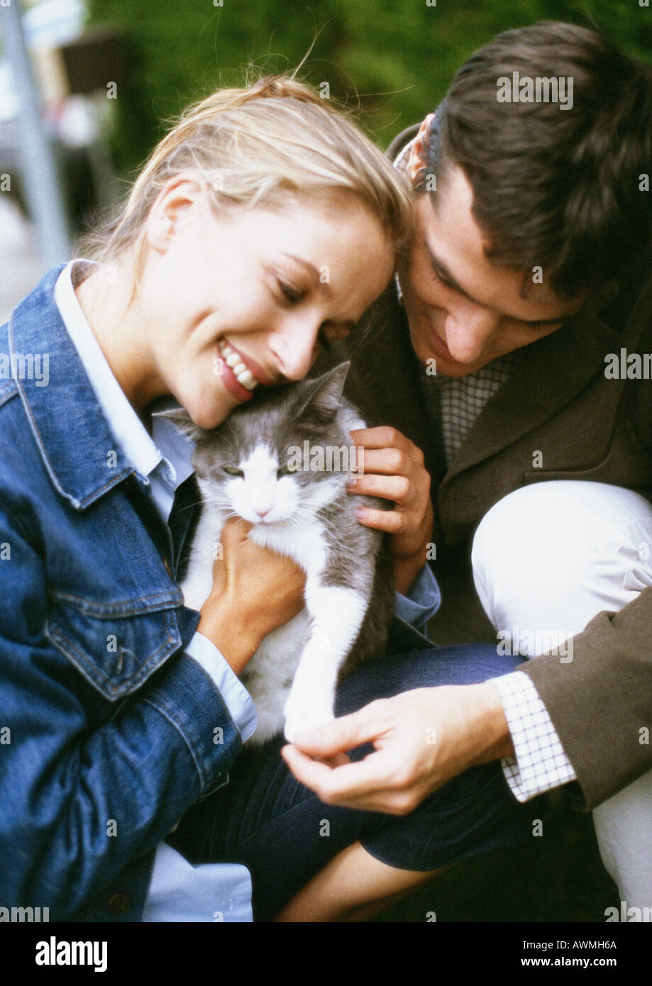 Man and woman holding cat, close-up Stock Photo