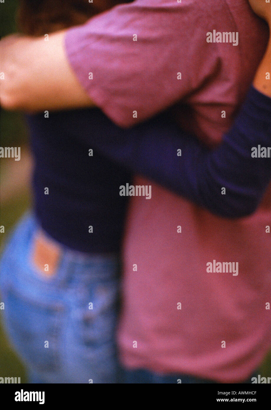 Two people hugging, mid-section, blurred Stock Photo
