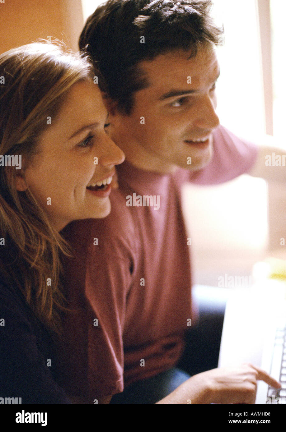 Man and woman side by side, smiling, side view Stock Photo