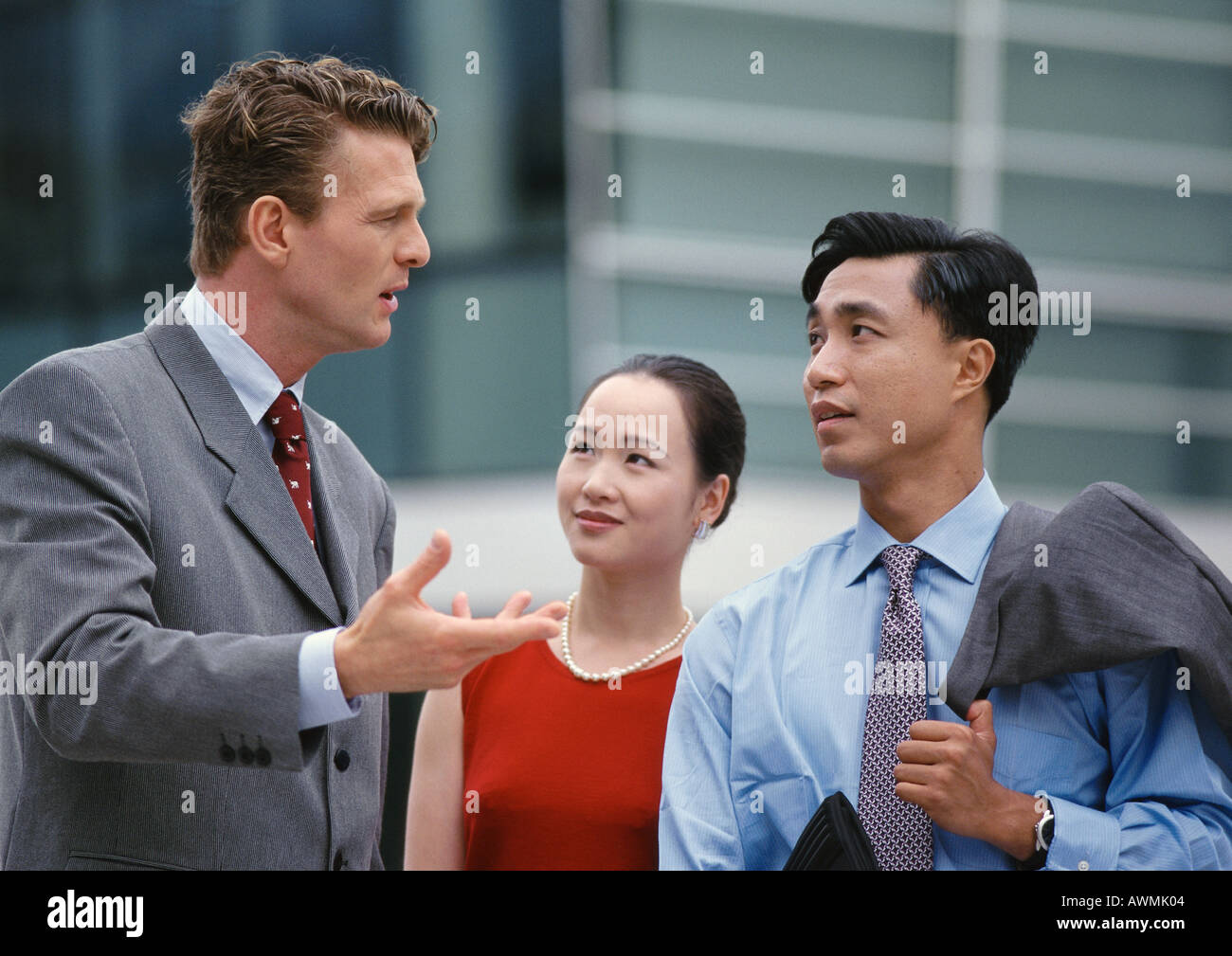 Business associates having discussion, one gesturing with hand Stock Photo
