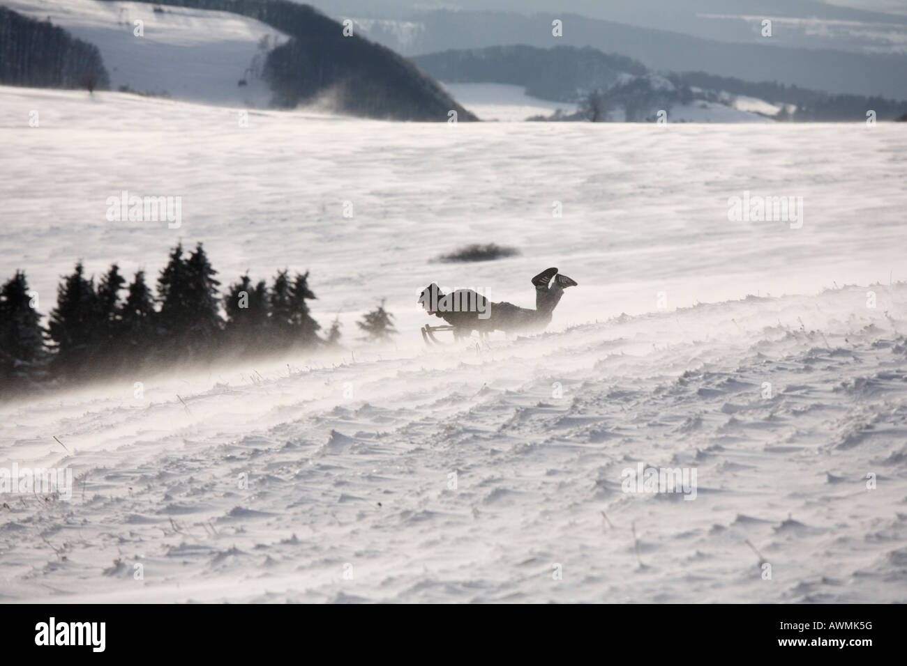 Sledder, blowing snow, Mt. Wasserkruppe, Rhoen Mountains, Hesse, Germany, Europe Stock Photo