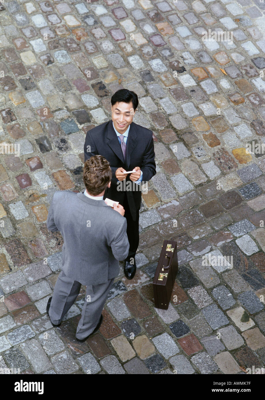 Two businessmen exchanging business cards, elevated view Stock Photo