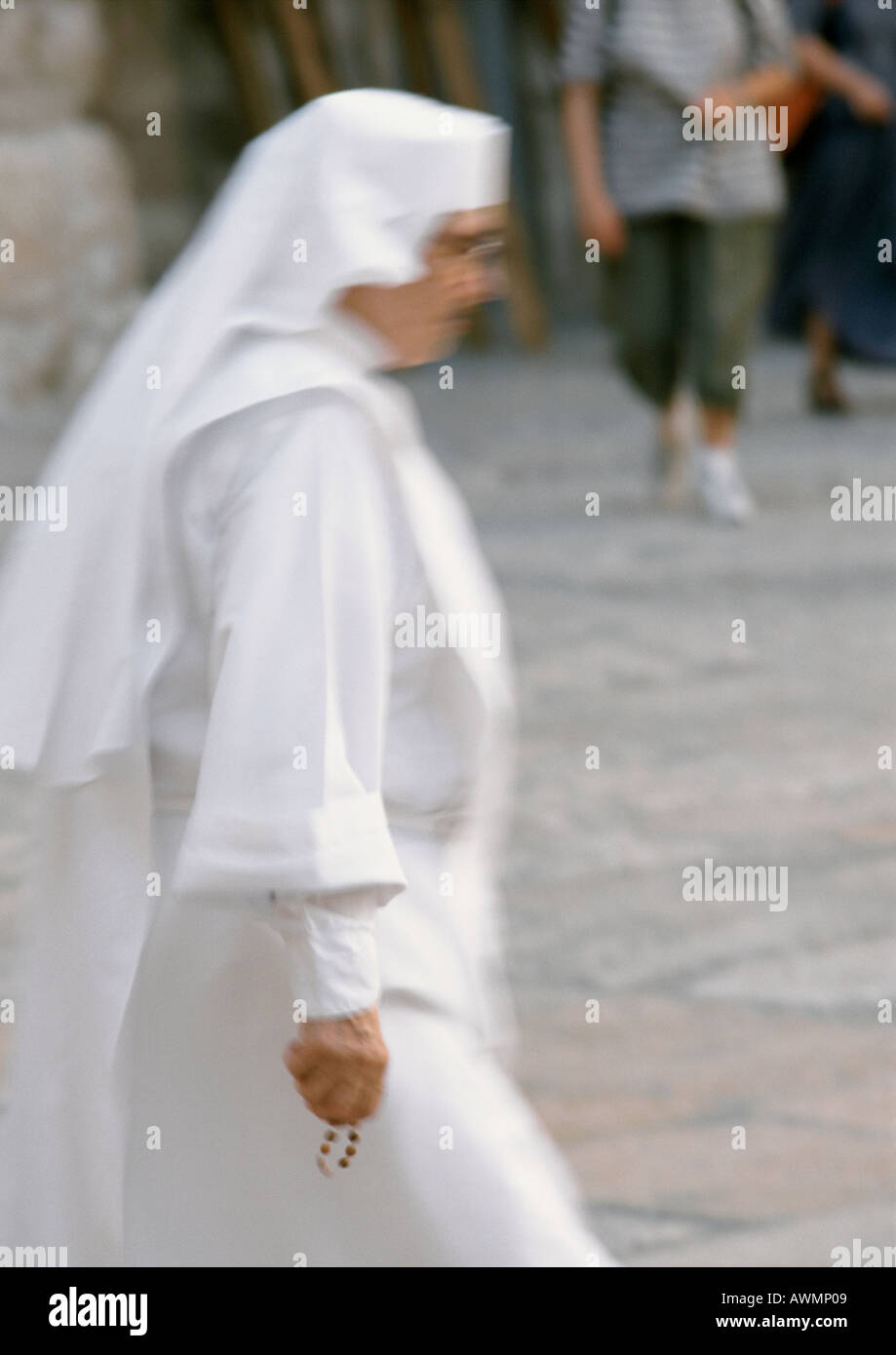 Nun walking in street, side view Stock Photo
