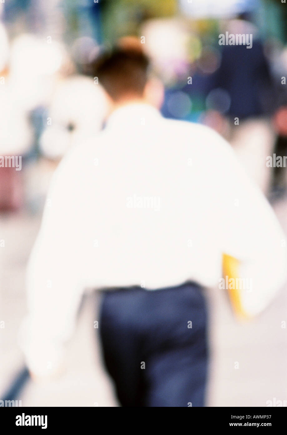 Man walking, rear view, blurred Stock Photo