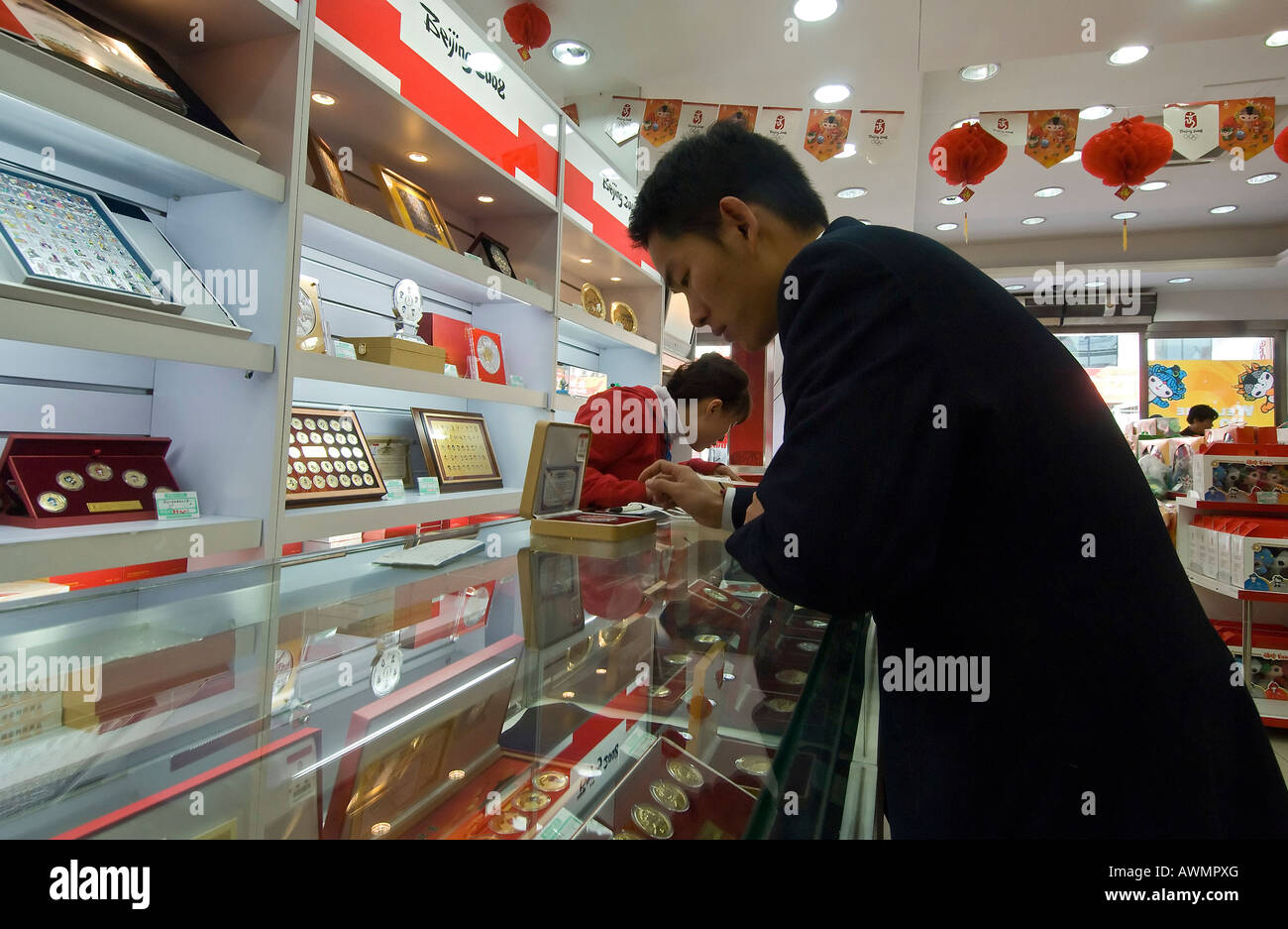 Shoppers buy Olympic souvenirs at a shop in Beijings Wanfujing shopping district Stock Photo