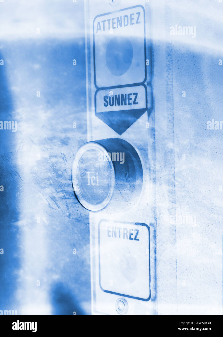 Security entrance button, with "wait, ring, here, enter" text in French, close-up Stock Photo