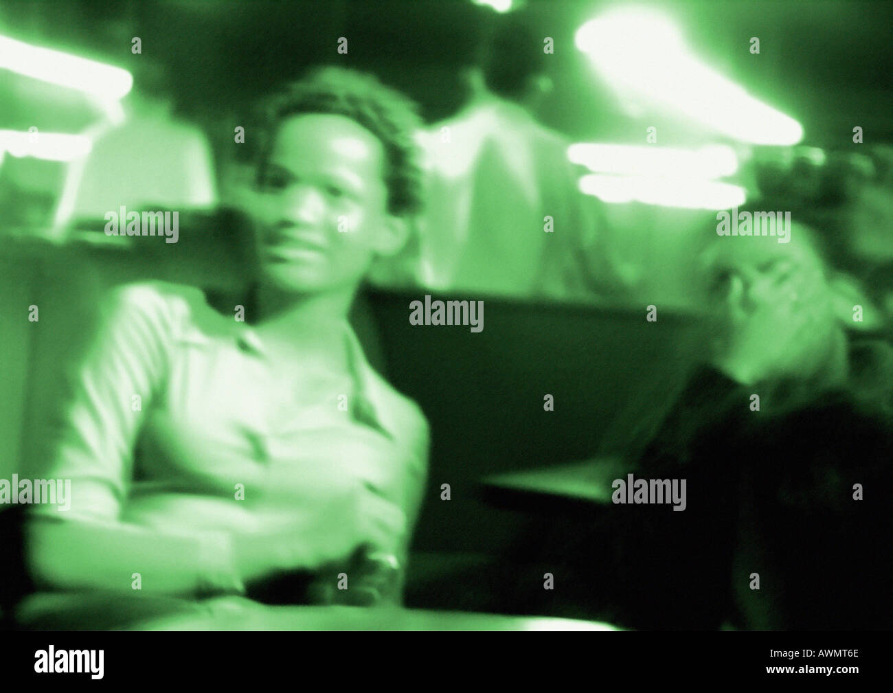 People in nightclub, blurred, green toned Stock Photo