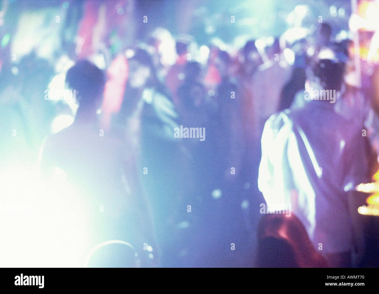 Crowd of people in night club, dancing, blurred Stock Photo