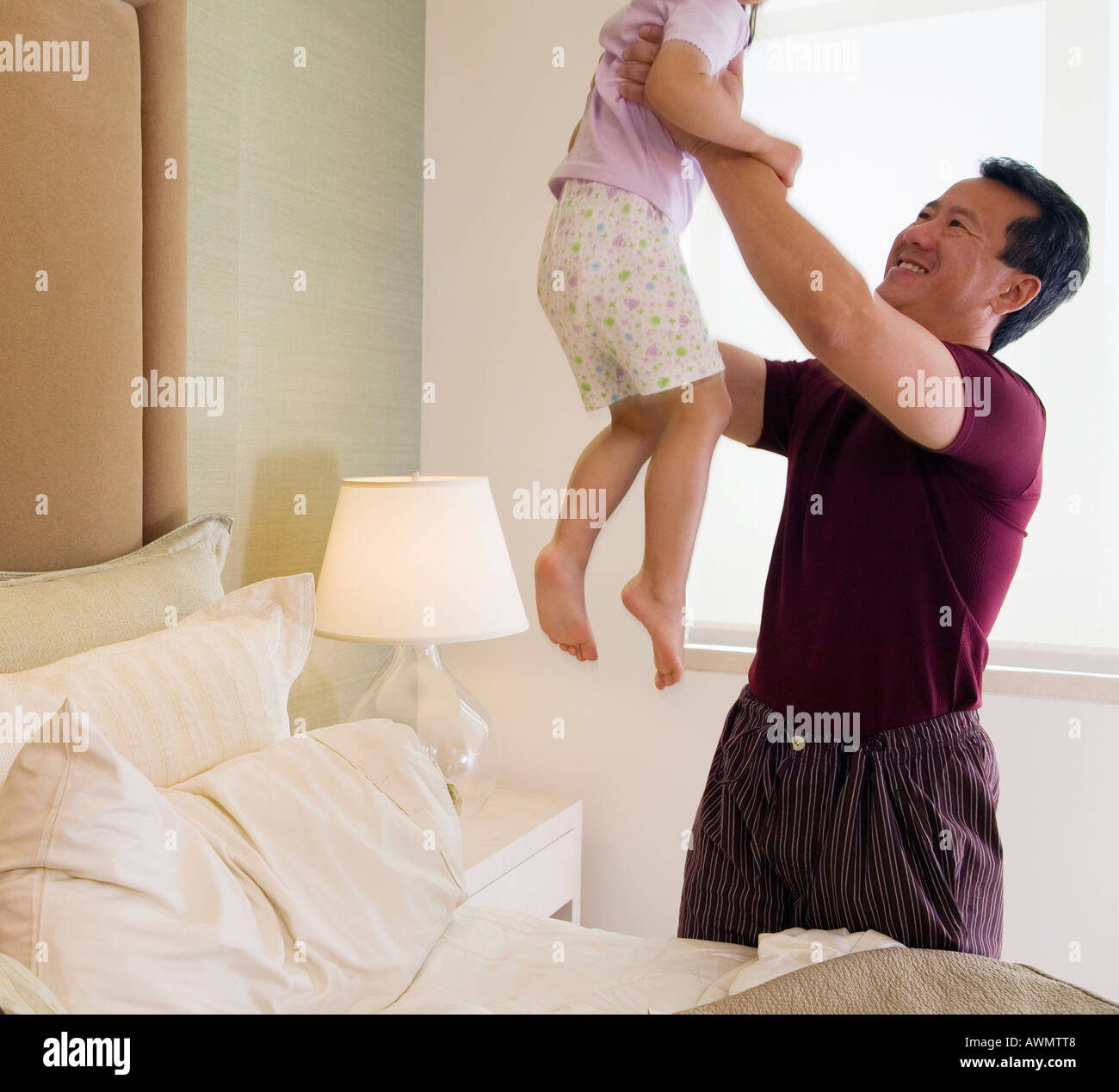 Asian father playing with daughter Stock Photo