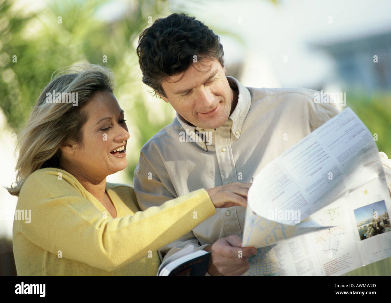 Man and woman looking at map, outside Stock Photo