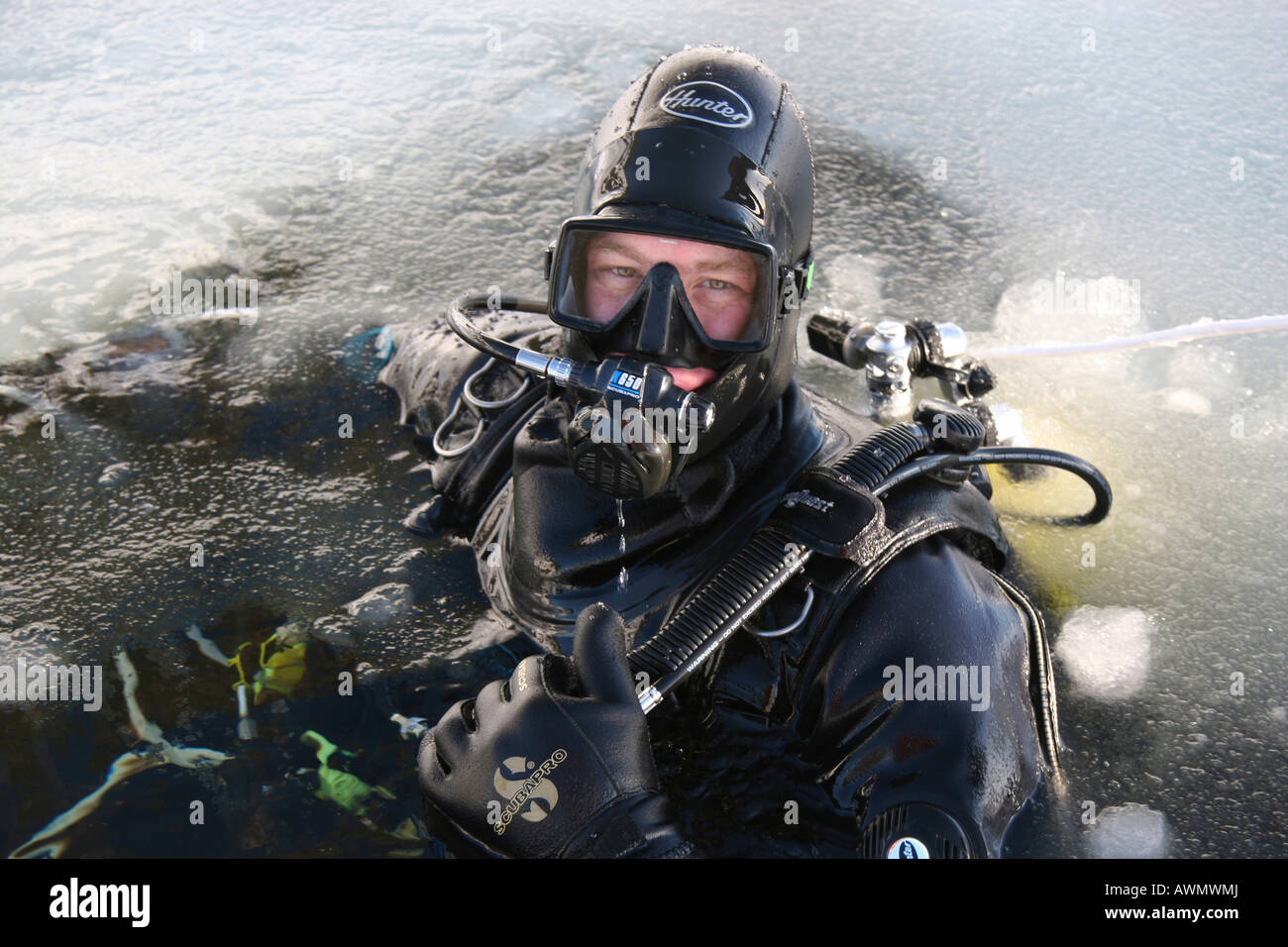 Diver in a ice hole. White Sea, White Karelia, Russia Stock Photo