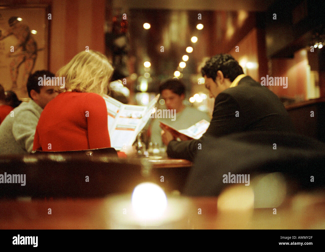 Friends in restaurant reading menu hi-res stock photography and images ...