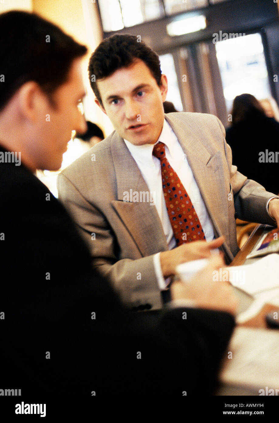 Businessmen talking together, close-up Stock Photo - Alamy
