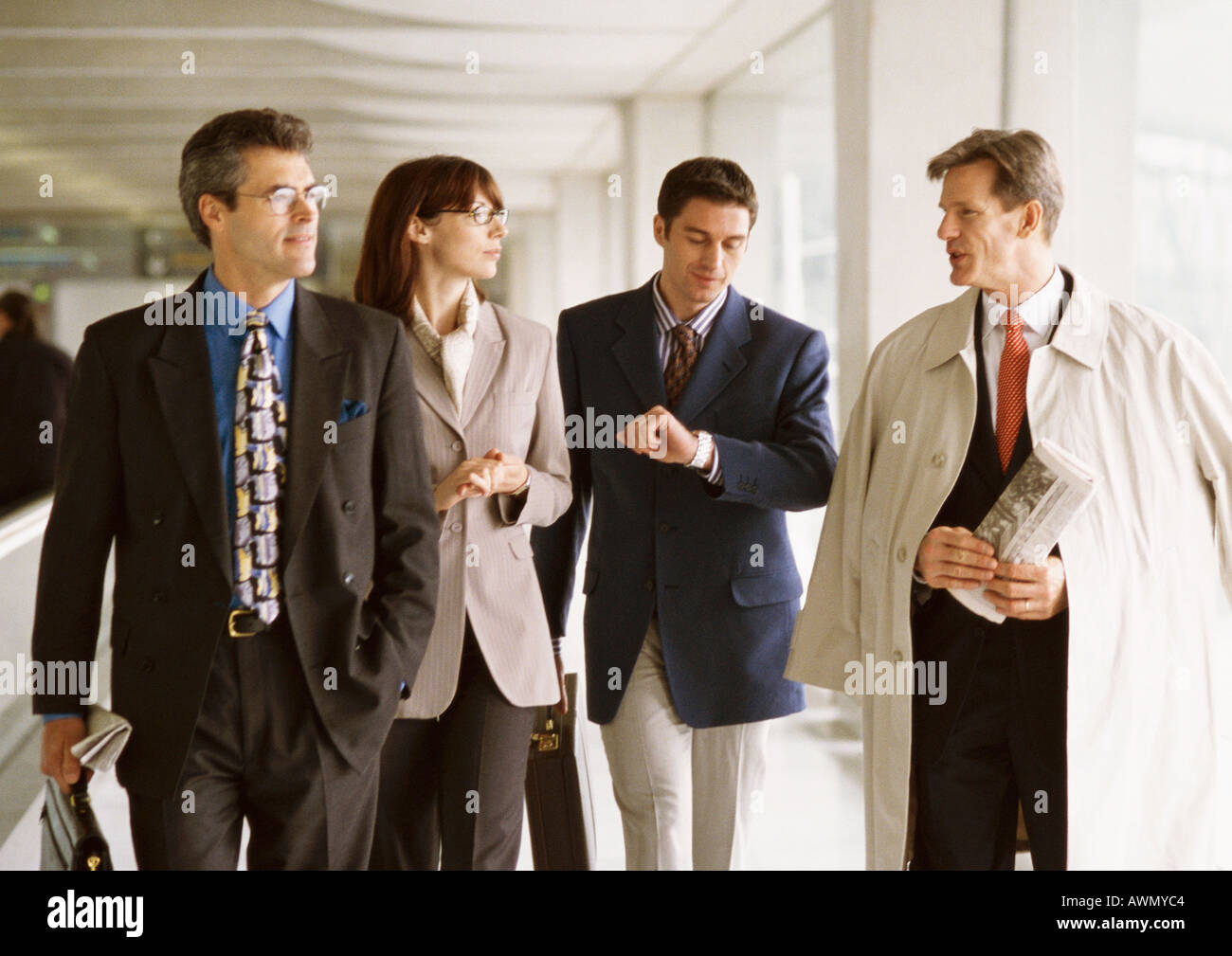 Group of business people walking together indoors, front view Stock Photo
