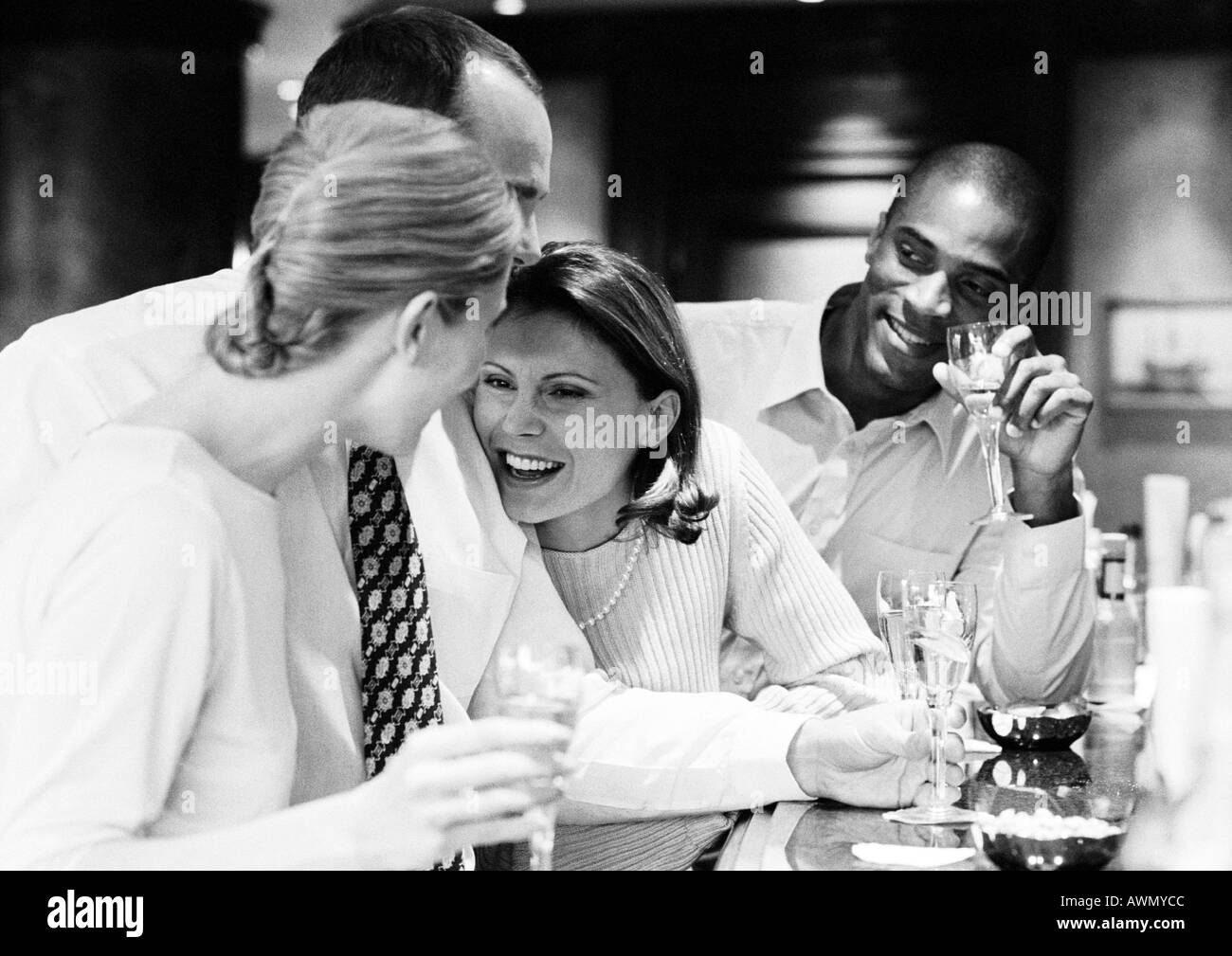 Group of business people socializing at bar, b&w. Stock Photo