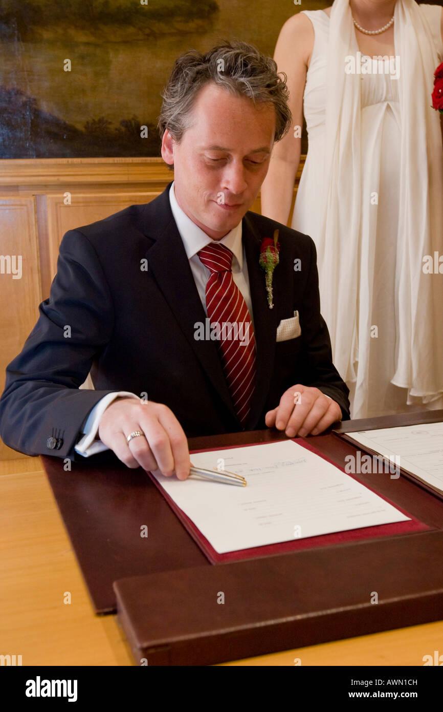 Groom signing marriage certificate Stock Photo