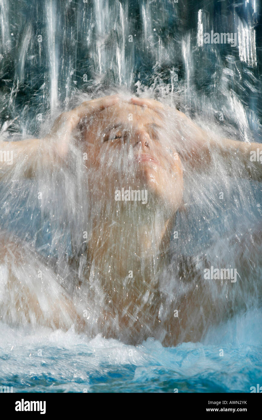 Woman showering under a waterfall Stock Photo Alamy