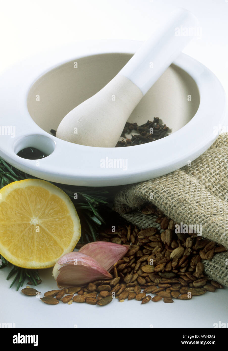 Pestle and Mortar with cloves and other Natural ingredients Stock Photo