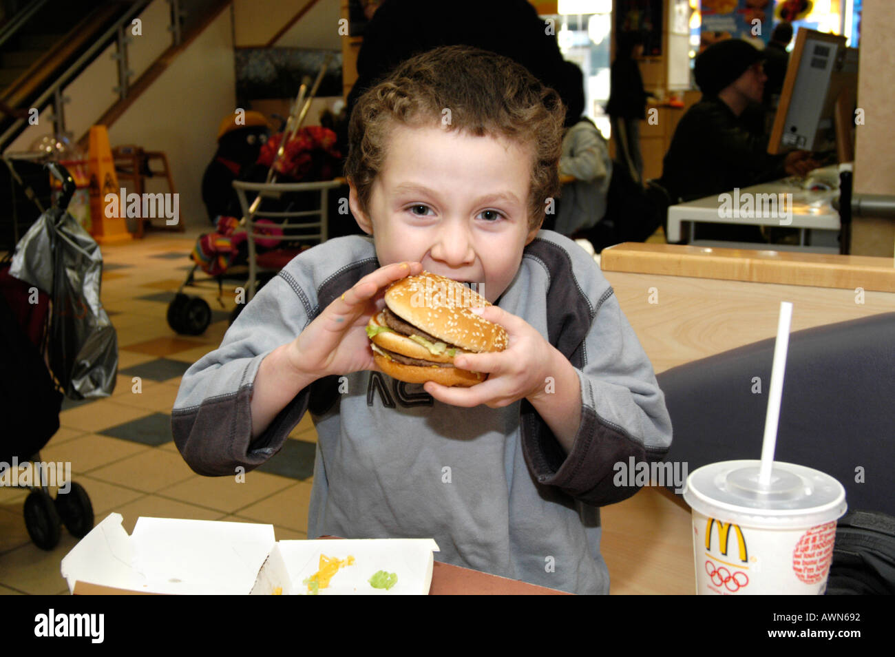 Small boy eating Mcdonald's Big Mac, England UK Stock Photo Alamy