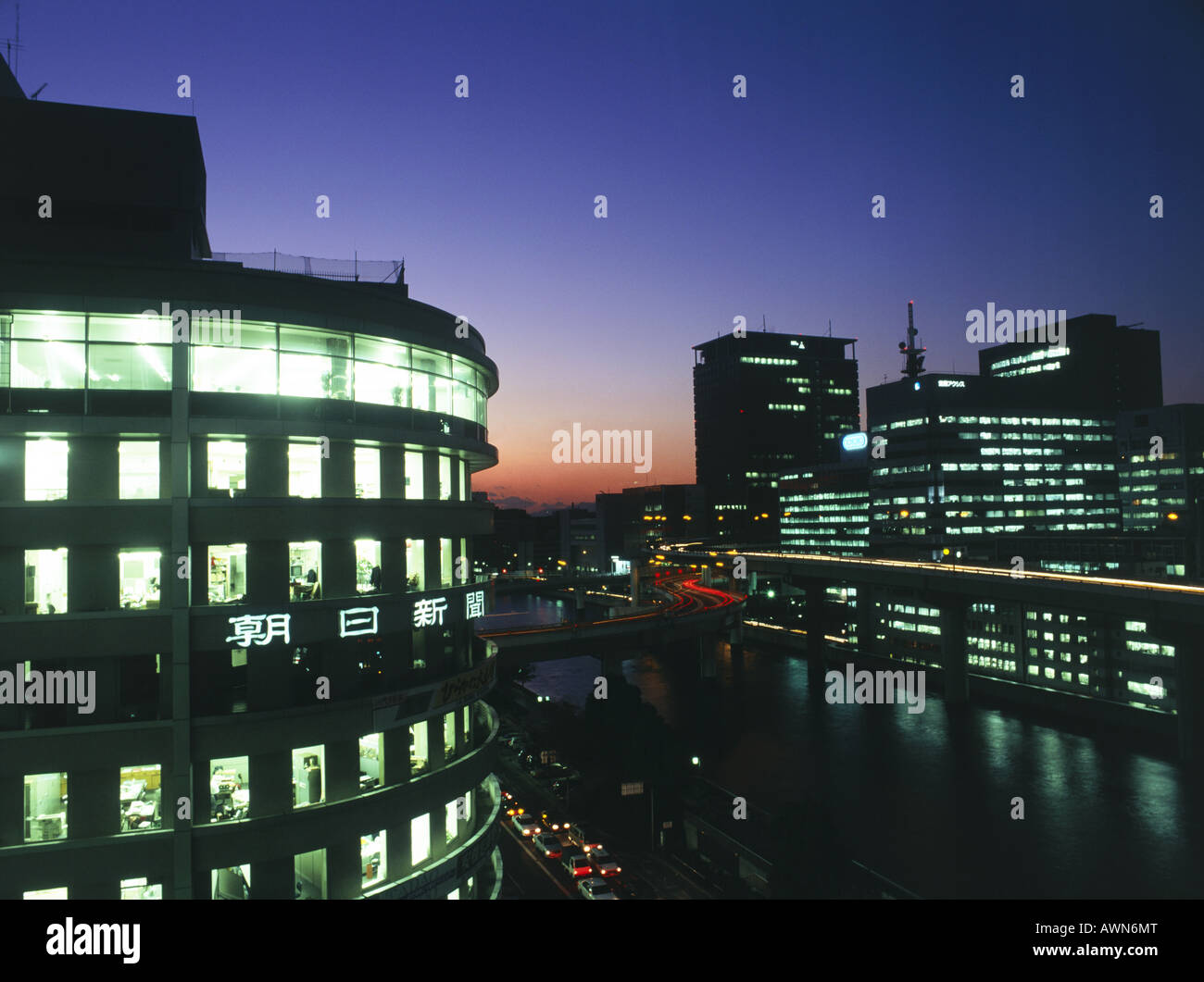 Buildings and streets lit up at night. Sunset. Stock Photo