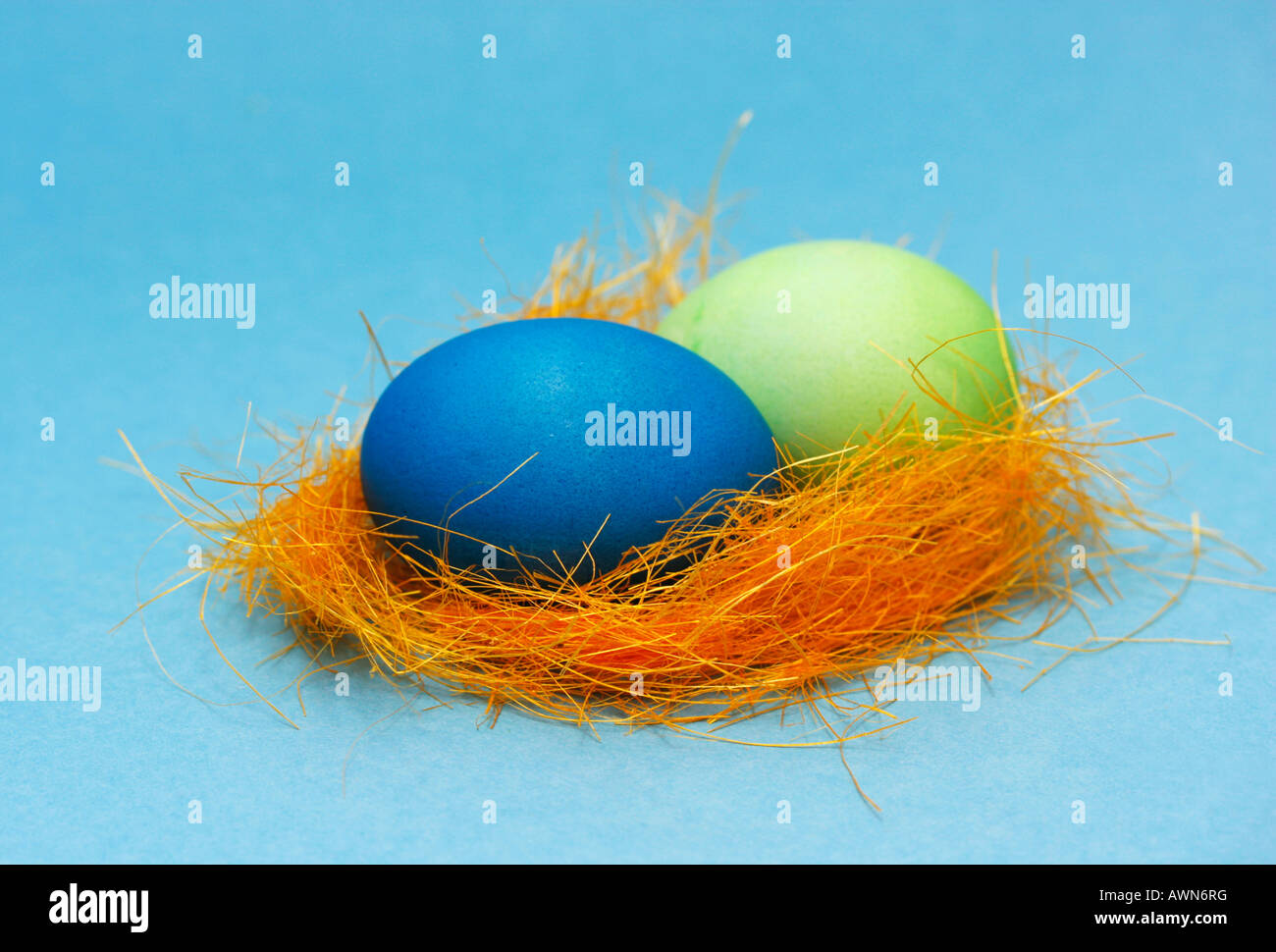 Two pastel-coloured Easter eggs in a nest Stock Photo