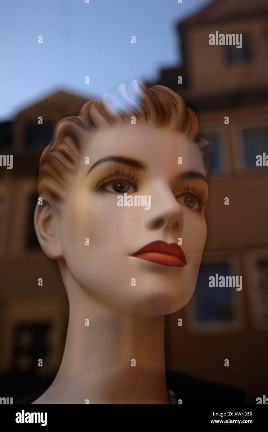 Head of a female mannequin in a shop window on which houses from the opposite side of the street are reflected, Naumberg, Saxon Stock Photo