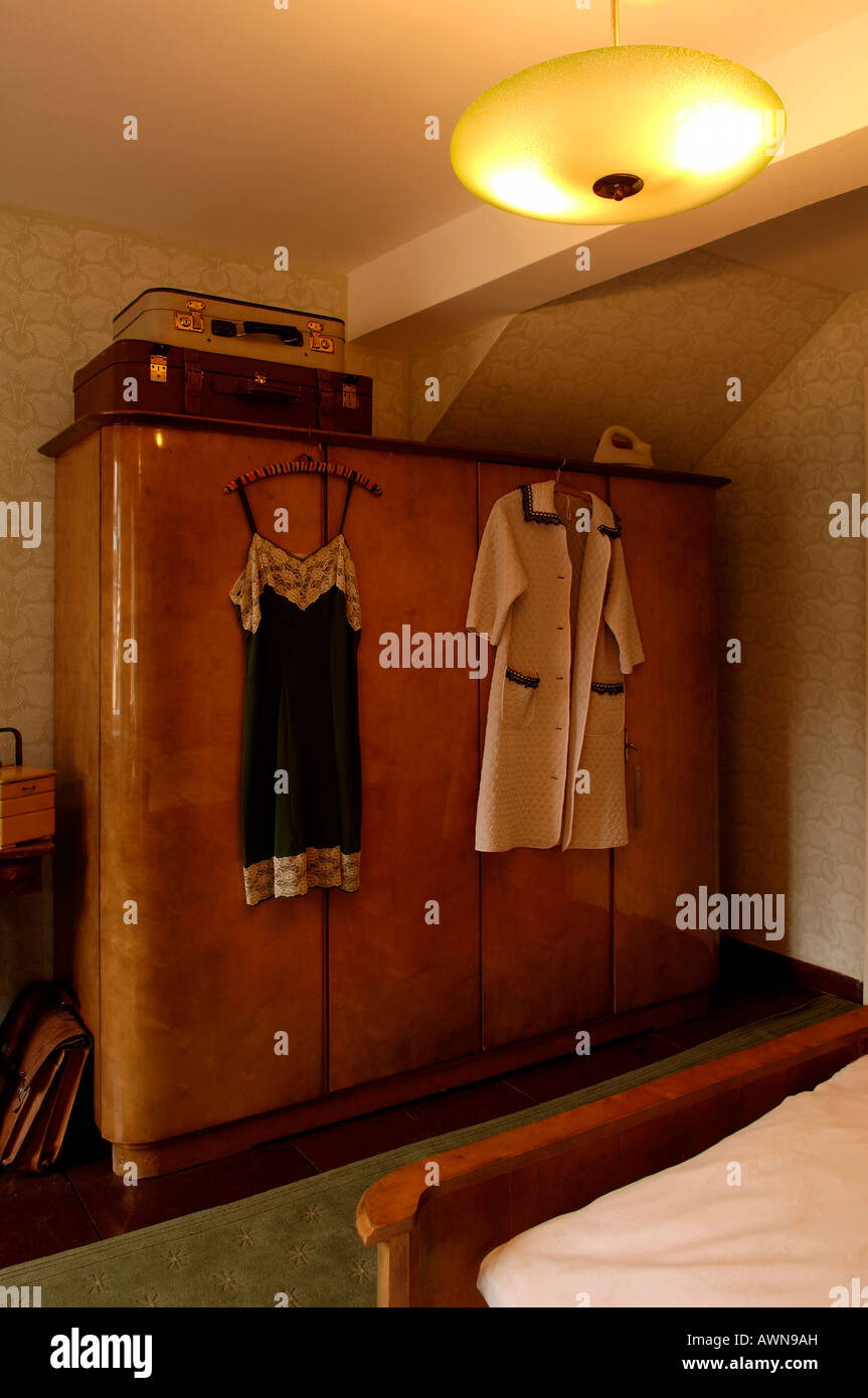 Two suitcases on top of a 1950s wardrobe, clothing handing on the outside, Lauf an der Pegnitz, Middle Franconia, Bavaria, Germ Stock Photo
