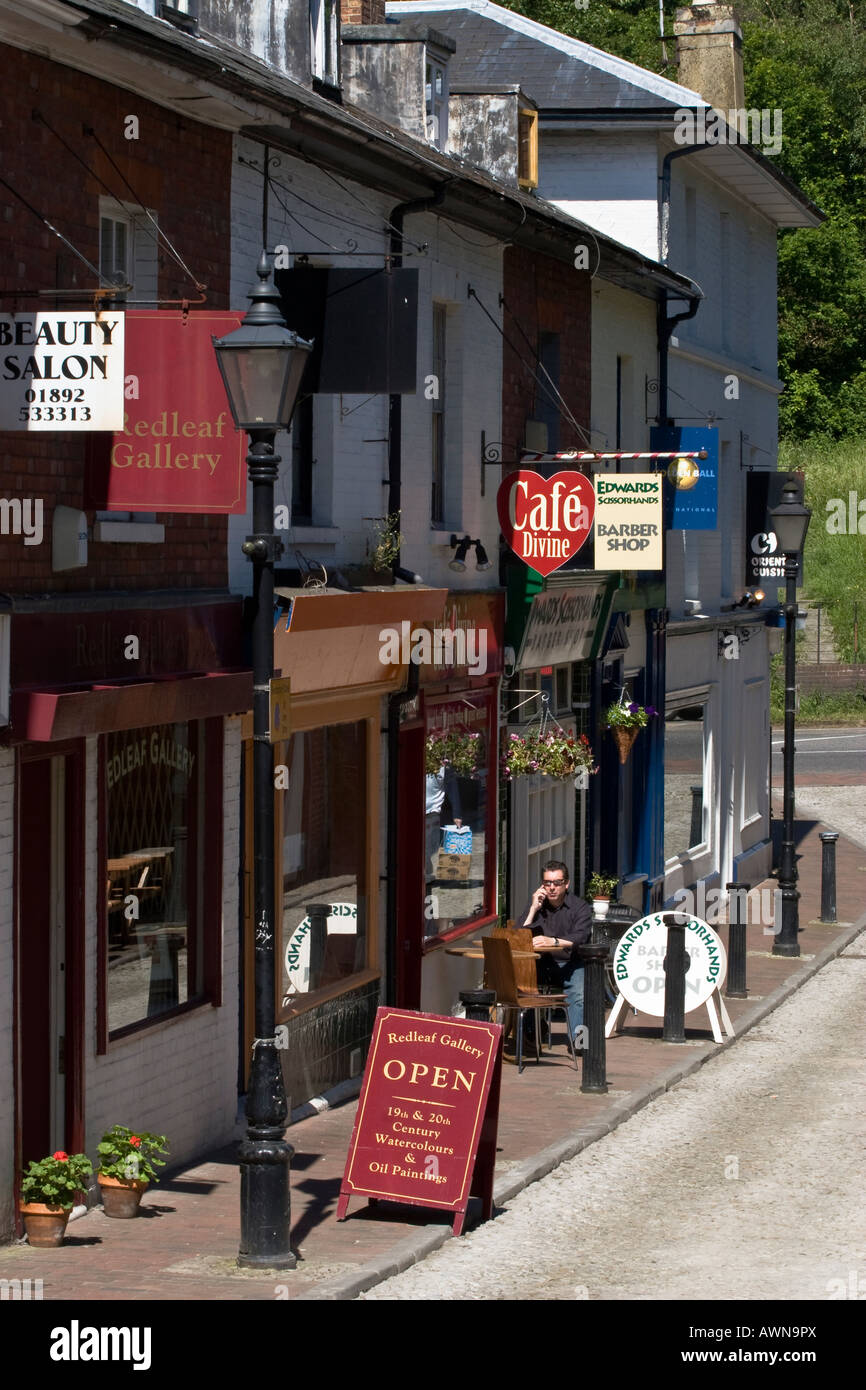 Shops on Castle Street, Royal Tunbridge Wells. A man sits outside a
