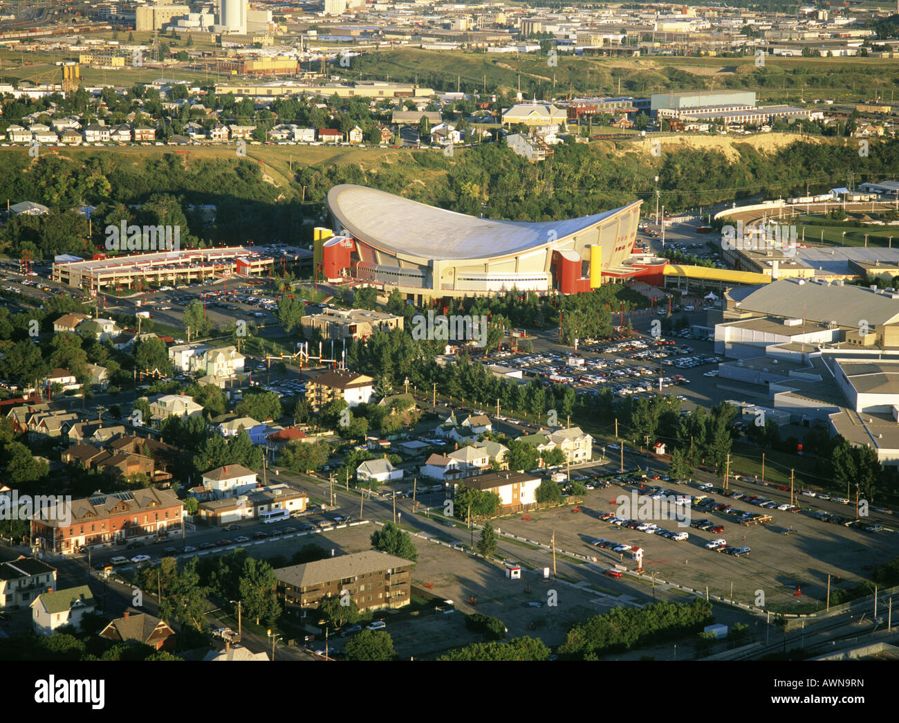Olympic Saddledome. Home of NHL Calgary flames. Buildings and trees. Cars. Stock Photo