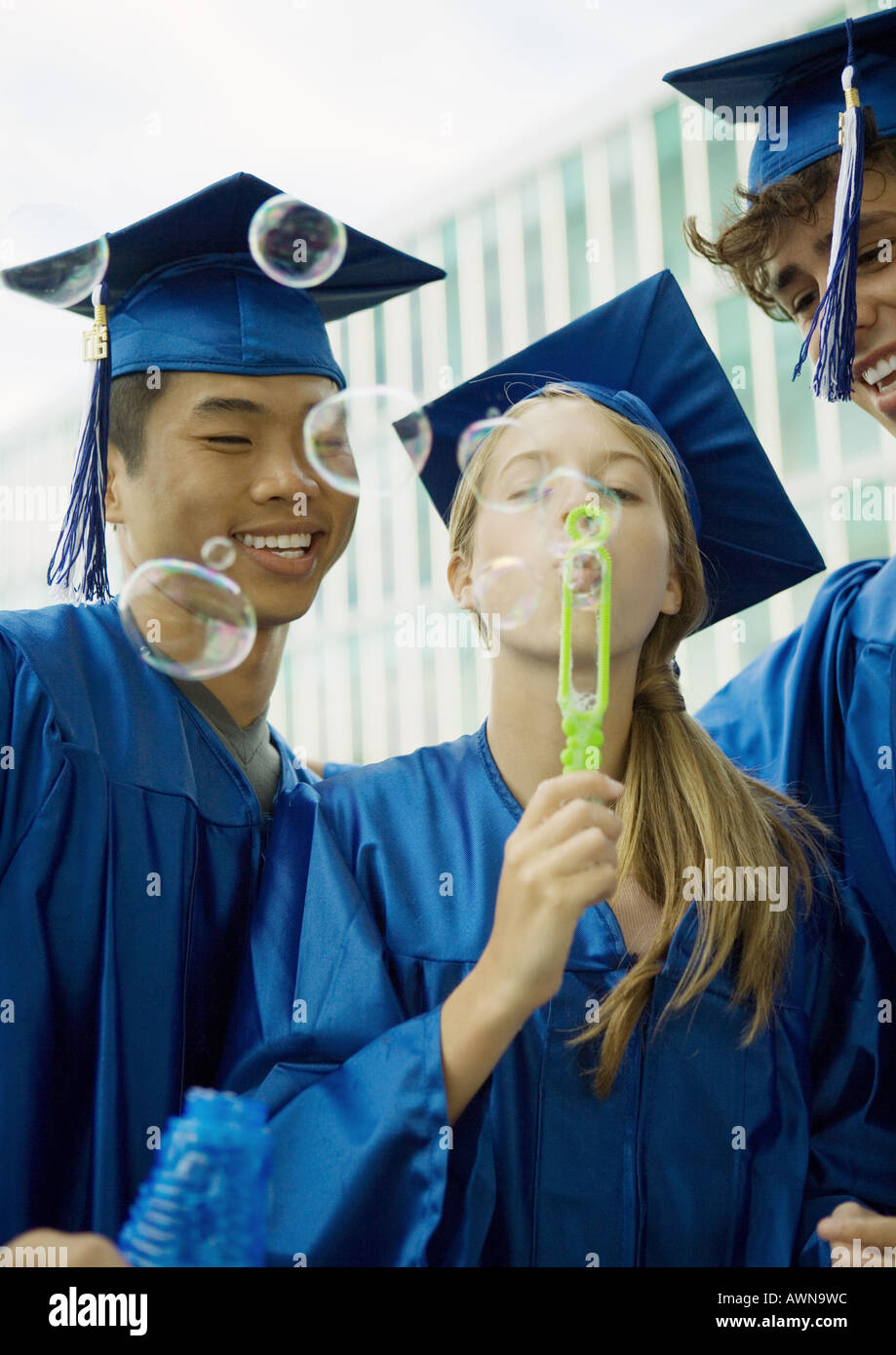 Graduates blowing bubbles Stock Photo - Alamy