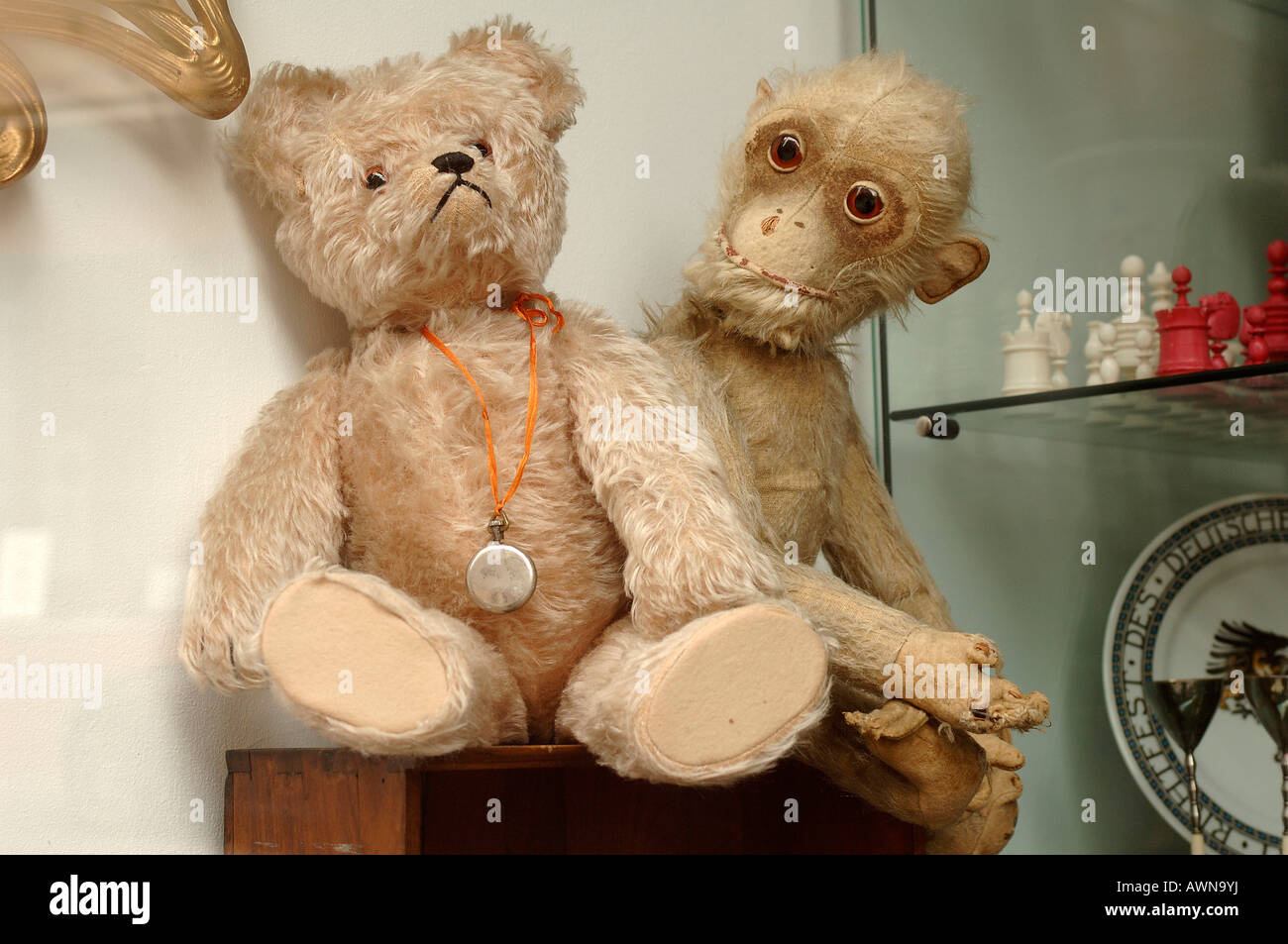 Two old, worn stuffed animals (teddy bear and monkey plush toy) at an antiques shop in Nuremburg, Middle Franconia, Bavaria, Ge Stock Photo