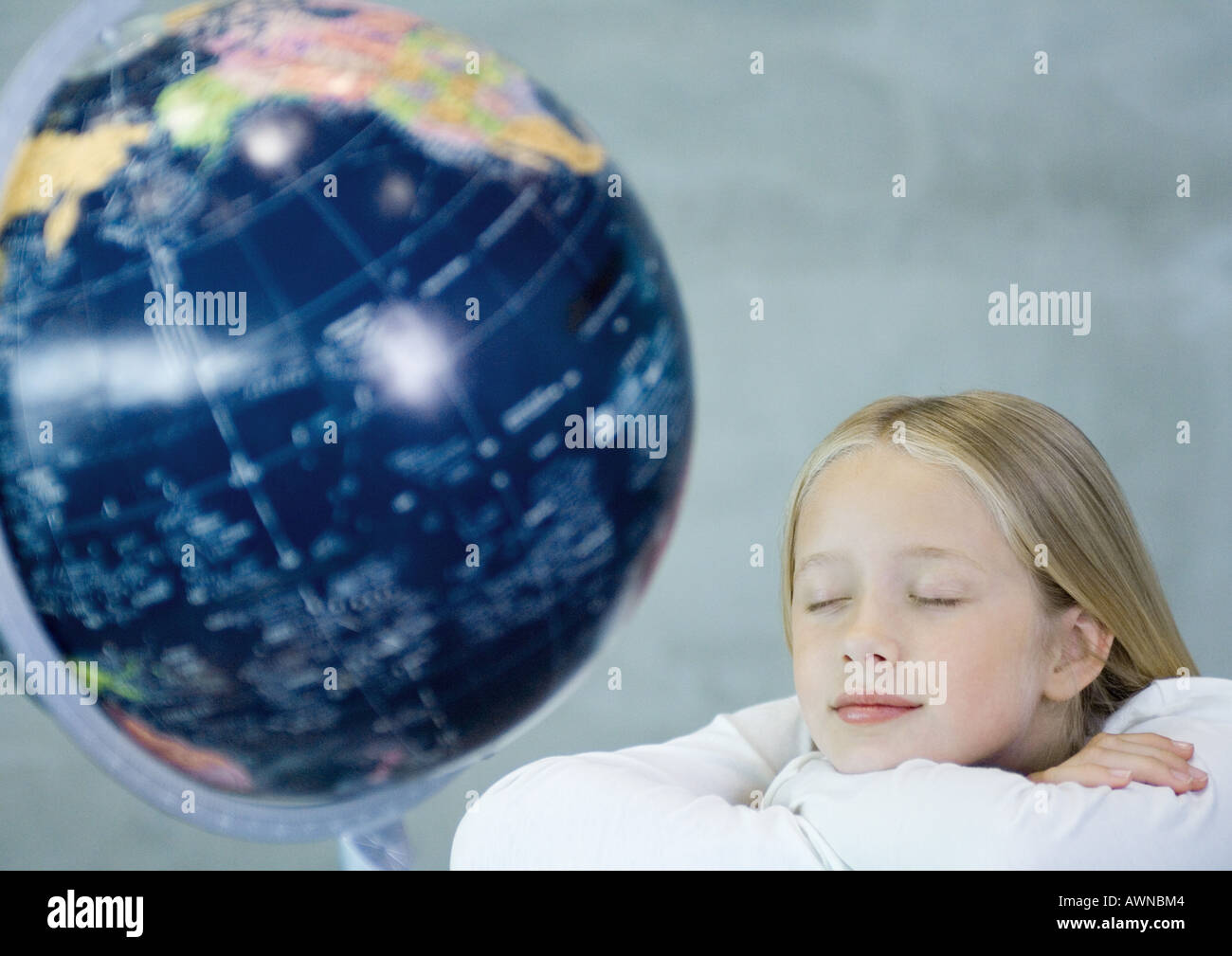 Girl dreaming near globe Stock Photo