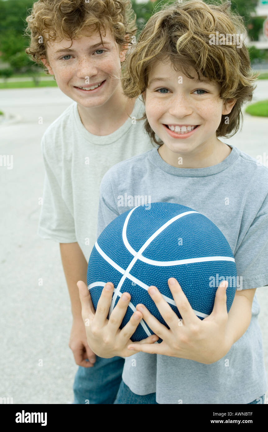 Two boys, one holding basketball, portrait Stock Photo