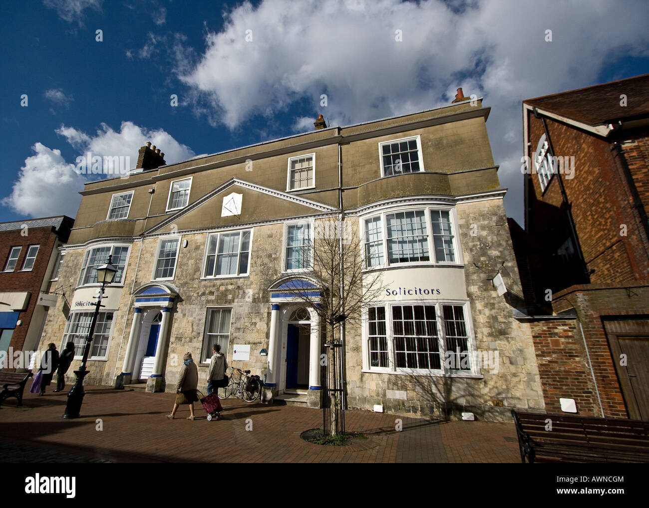 wideangle view of building in cliffe high street, lewes with sundial and shoppers Stock Photo